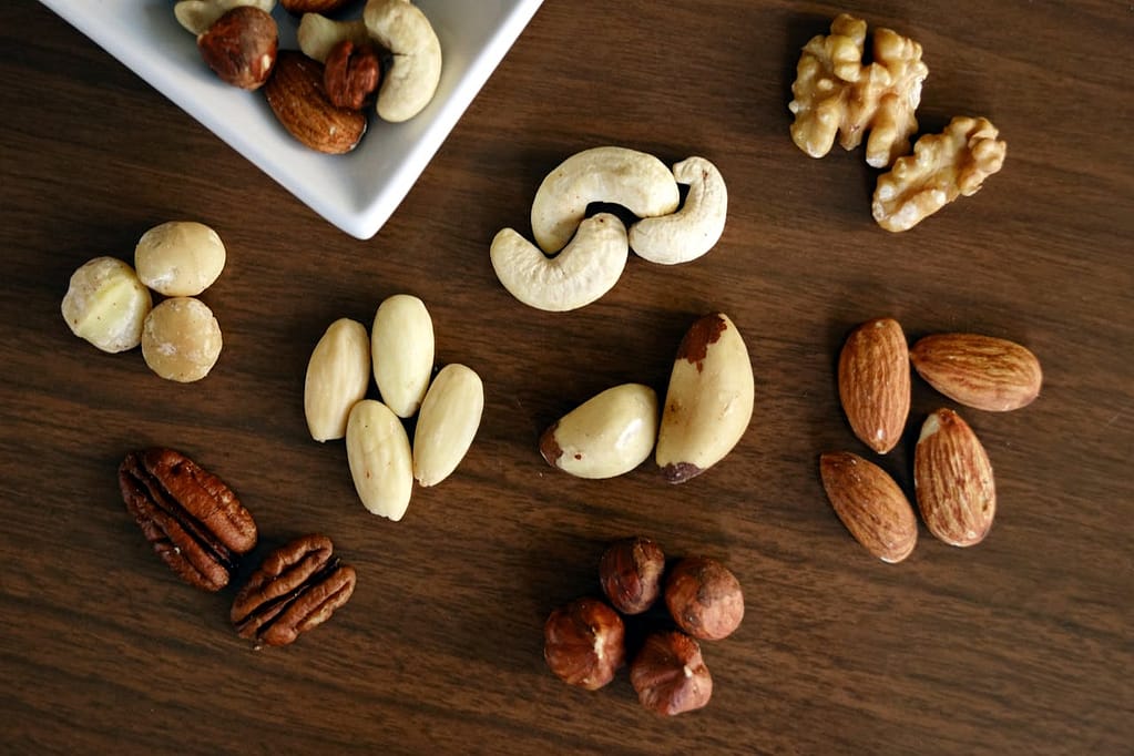 Early morning exercise: The ultimate key to a healthy and productive life Close-up of various nuts on a wooden table, showcasing healthy snacking options.